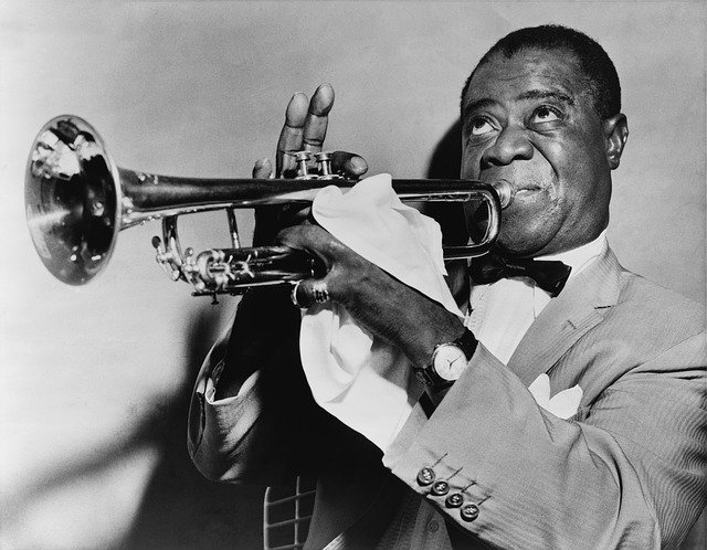 Louis Armstrong plays the trumpet. 