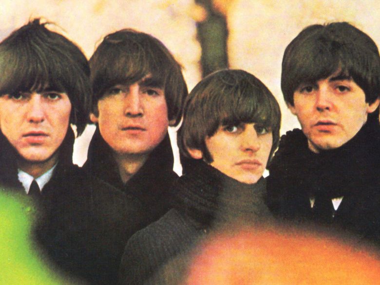 The four Beatles posed together in black. 