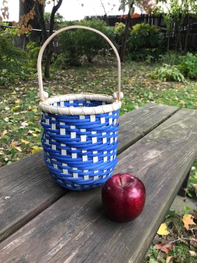 blue spiral basket on a picnic table
