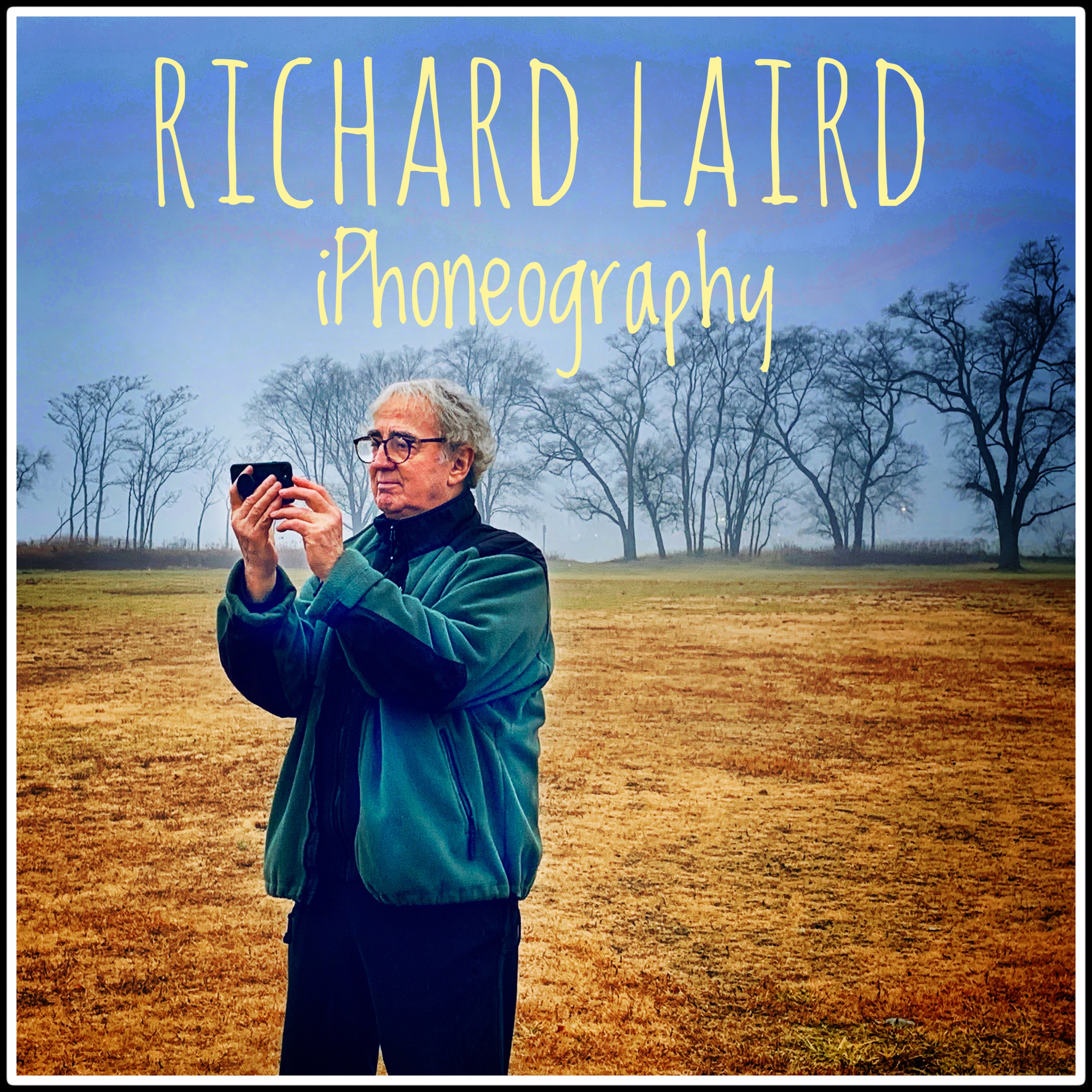Richard Laird against a landscape taking a photo