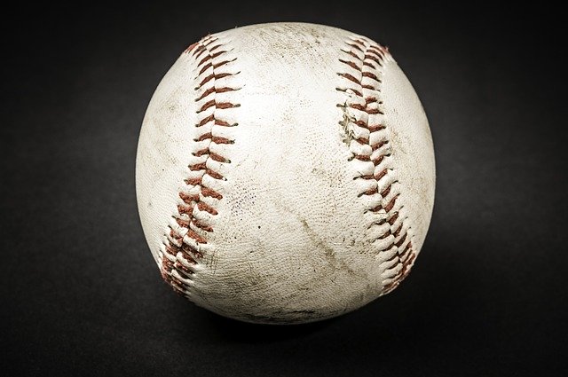 a old baseball on a black background
