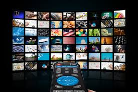 television with many apps on it and a remote pointed at it