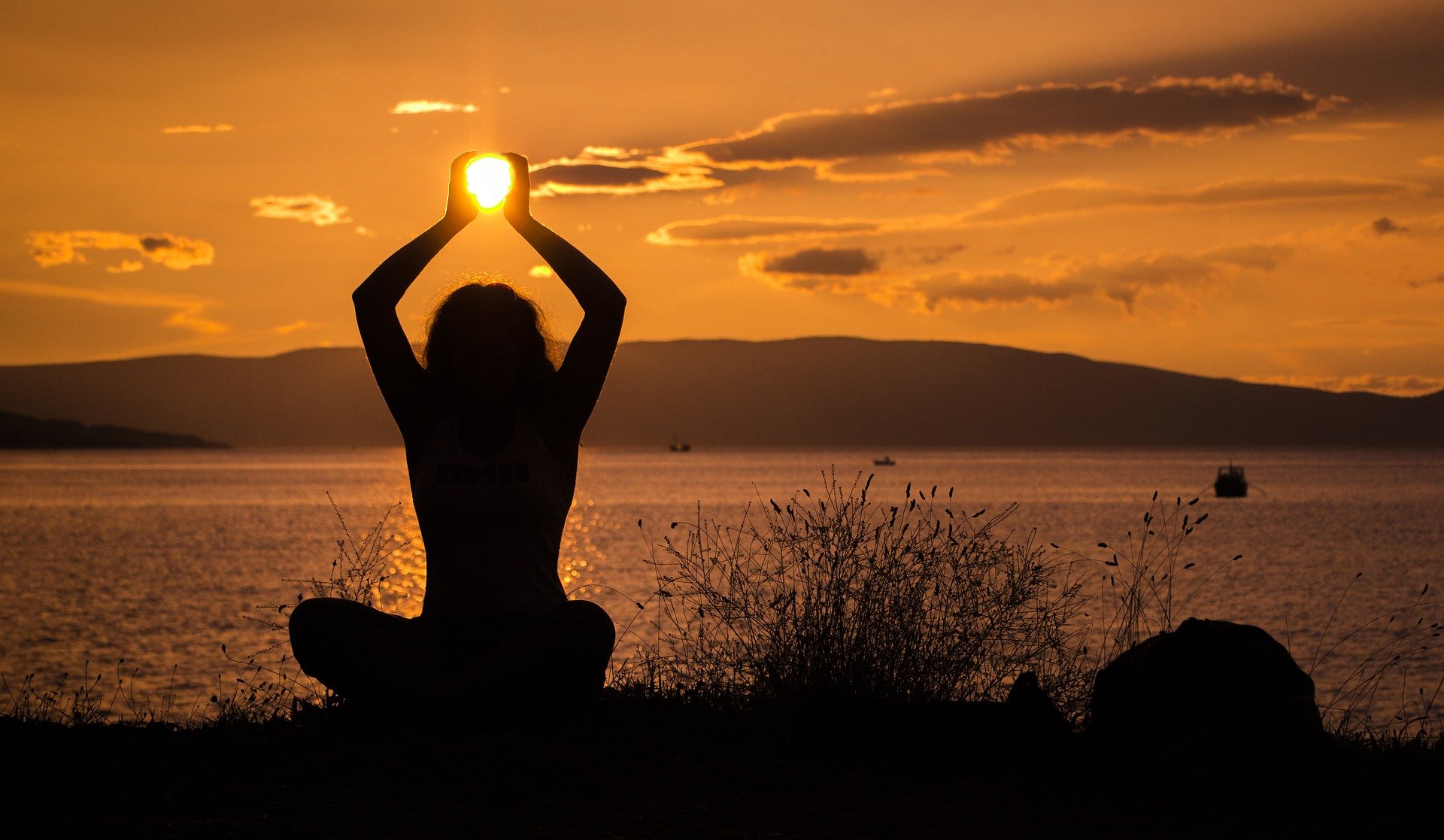 holding the sun in a yoga pose