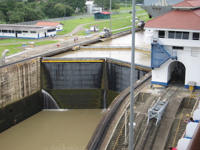 a photo of canal lock with water pouring in to lift the boat up