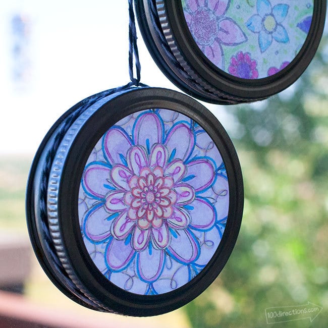two round sun catchers with flowers colored in with pencil