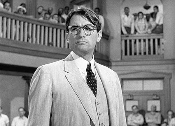 Black and white still from the movie To Kill a Mockingbird that shows Gregory Peck as Atticus Fitch 
