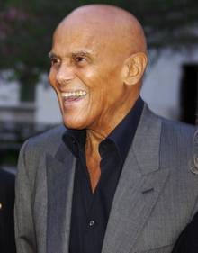 Color photo of Harry Belafonte in profile, smiling