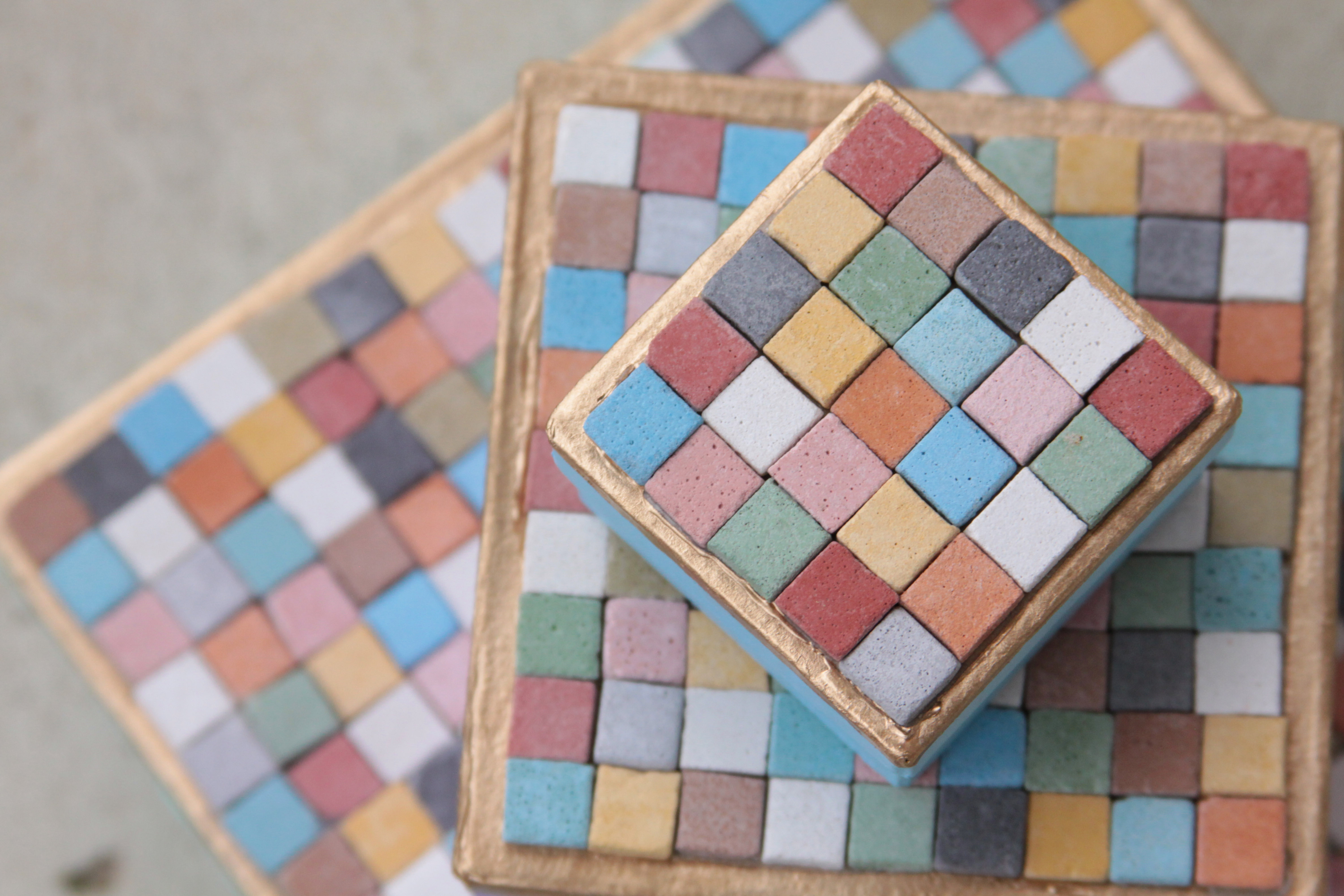 square boxes topped with colorful square tiles