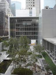 color photo of a glass and grey concrete building 
