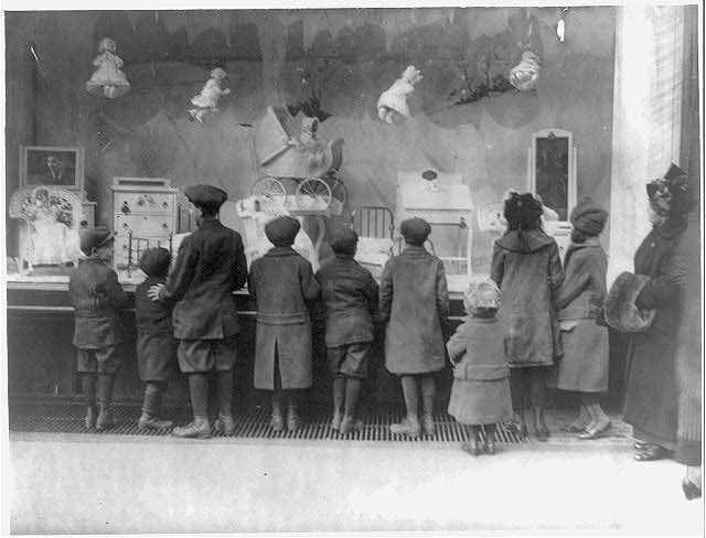 Vintage photo of children looking at a holiday window display