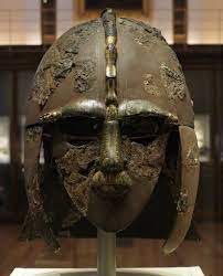 A photo of a copper helmet known as the Sutton Hoo helmet.
