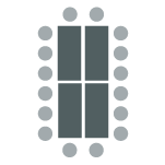 Tables pushed together in the center, chairs arranged evenly around. 