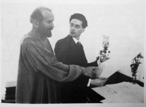 Schiele and Klimt seated at a drawing table