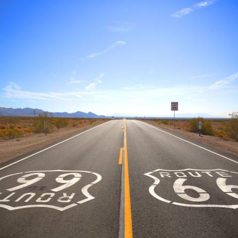 photograph of a two-lane road with 'Route 66' painted on both sides 