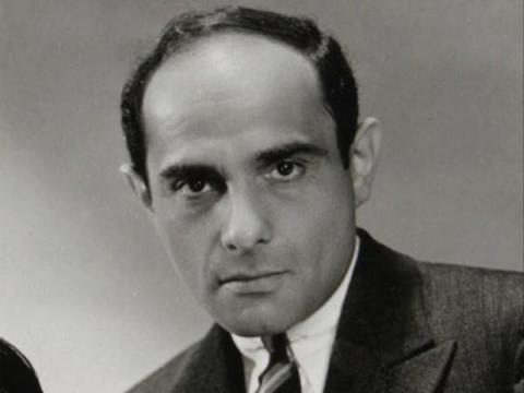 Black and white portrait photo of Lorenz Hart, looking at the camera with a serious expression 