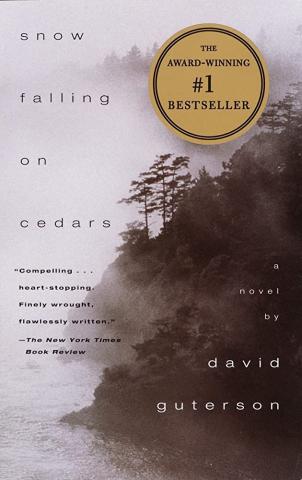 book cover of Snow Falling Cedars shows a mist covered cliffside in sepia tones 