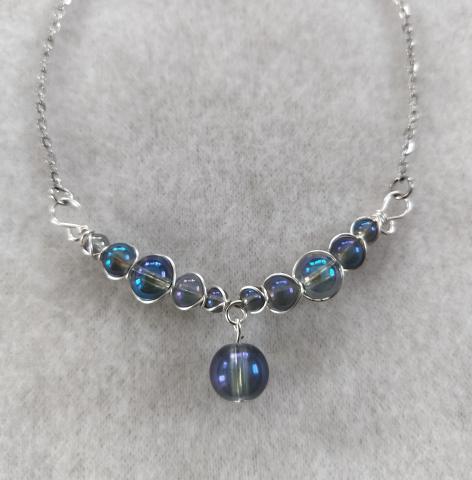 silver necklace with blue stones wrapped 