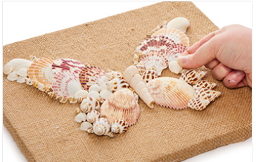 shells shaped like a butterfly on burlap