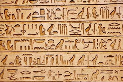 light brown tablet of hieroglyphics 
