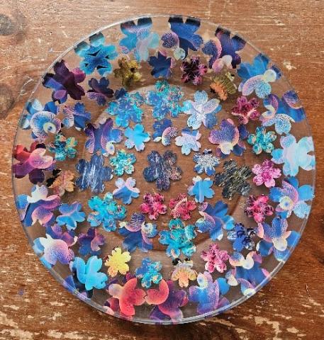 glass plate with a patter of paper flowers on it 