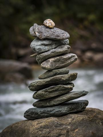 stacked stones in front of a rushing river