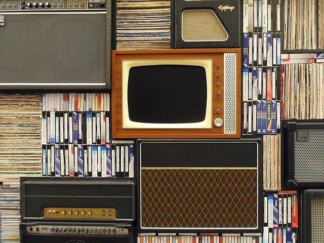 stack of records and an old tv turned off 