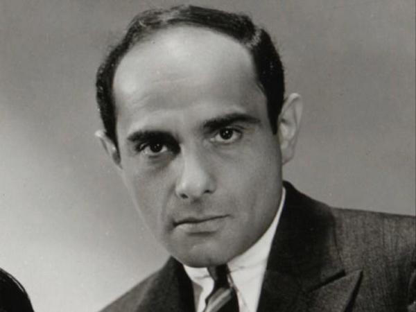 Black and white portrait photo of Lorenz Hart, looking at the camera with a serious expression 