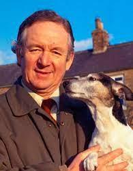 color photo of James Herriot with a dog. 