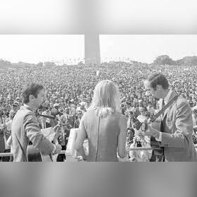 black and white photo of musicians playing a large crowd in front of the Washington monument during the March on Washington