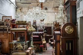 Storage room full of large wood furniture and a few chandeliers 