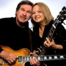 color photo of Tom and Sandy Doyle with their guitars