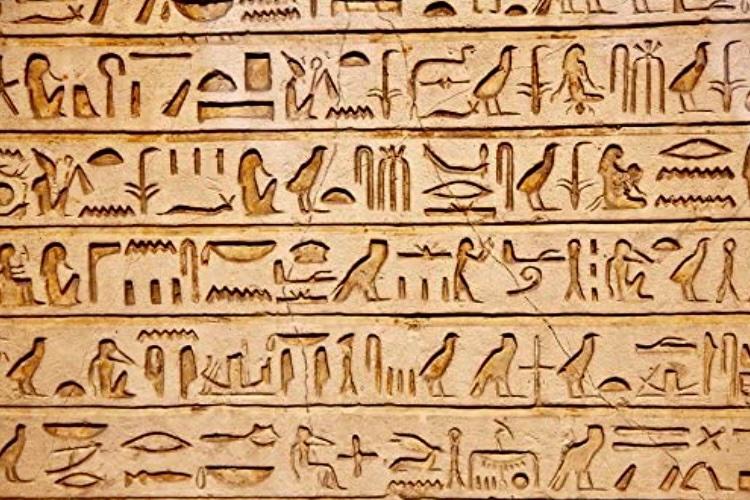 light brown tablet of hieroglyphics 